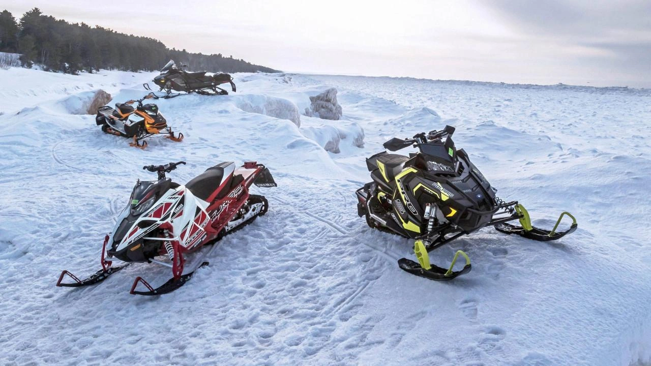 group of Polaris & Yamaha snowmobiles