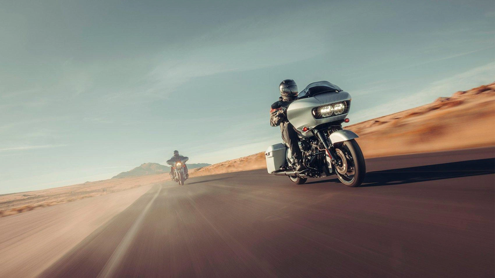 Harley-Davidson motorcycles riding on an open road