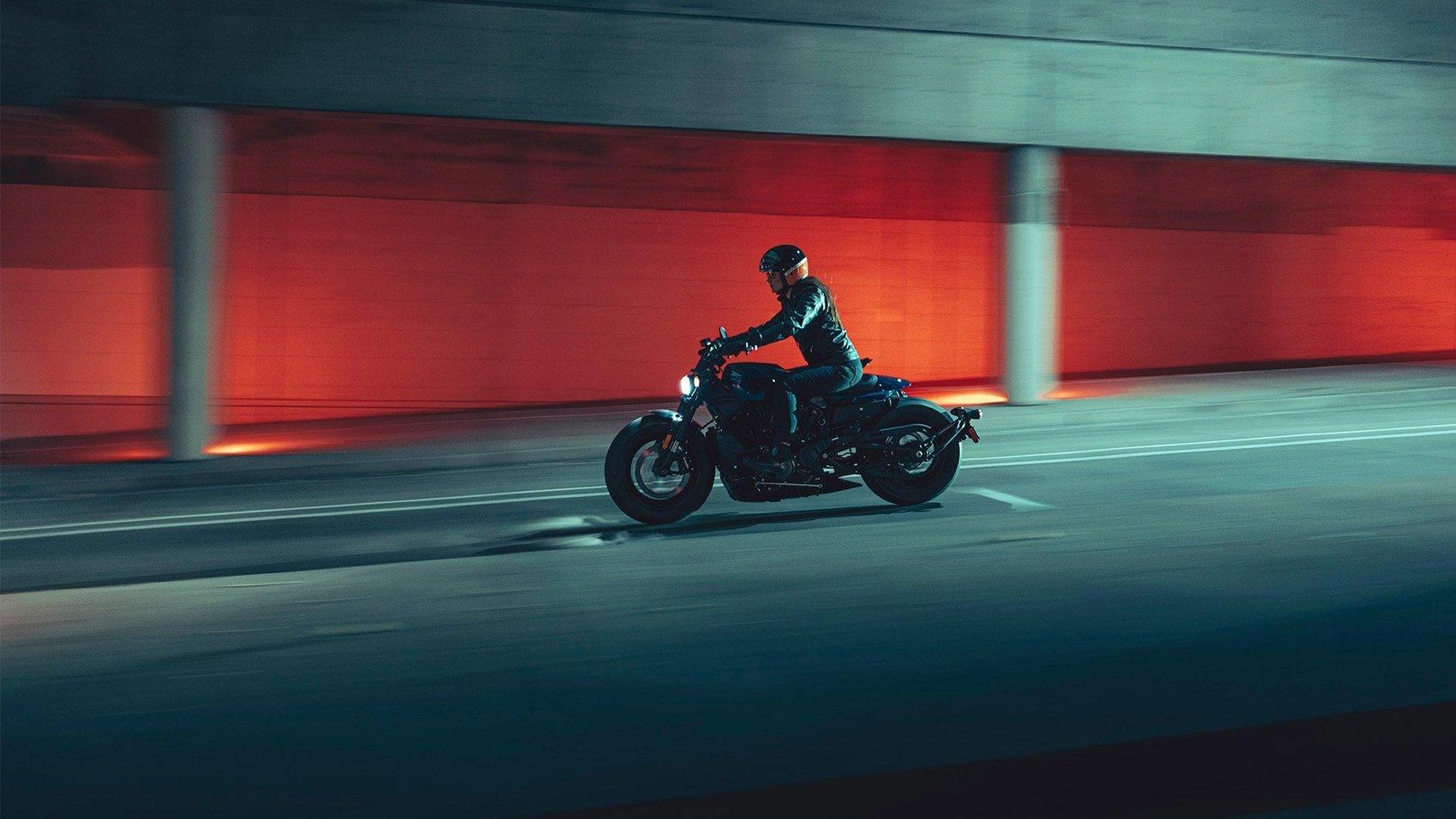 Harley-Davidson motorcycle riding through an urban tunnel