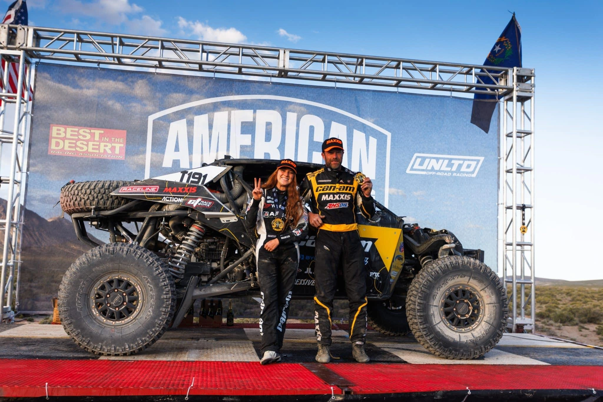 Kyle Chaney (right) and co-driver Sadyiie Gray on the podium after winning the Silver State 300.
