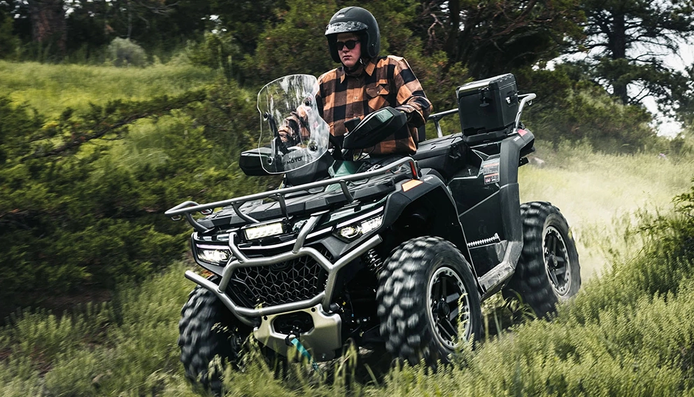 View of the CFMOTO CFORCE 1000 Overland in full swing in a field and forest