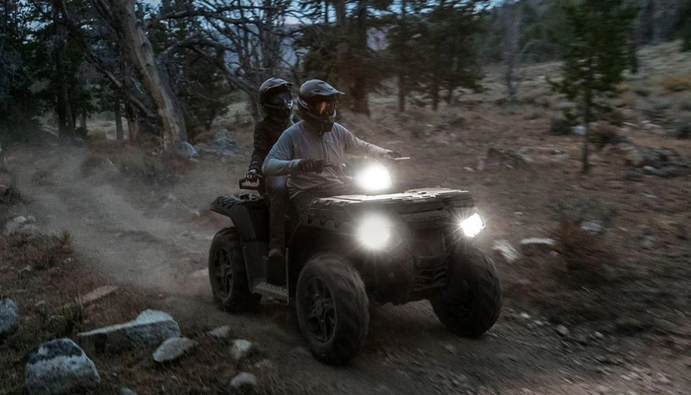 View of the Polaris Sportsman 850 Touring on a sandy road before dark