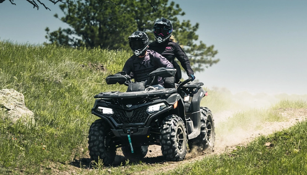 A view of the CFMOTO CFORCE 600 Touring in full swing in a field