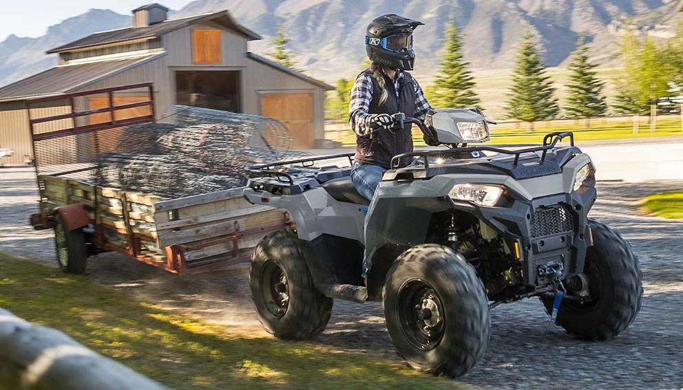 View of the Polaris Sportsman 450 pulling a cart with a skewer