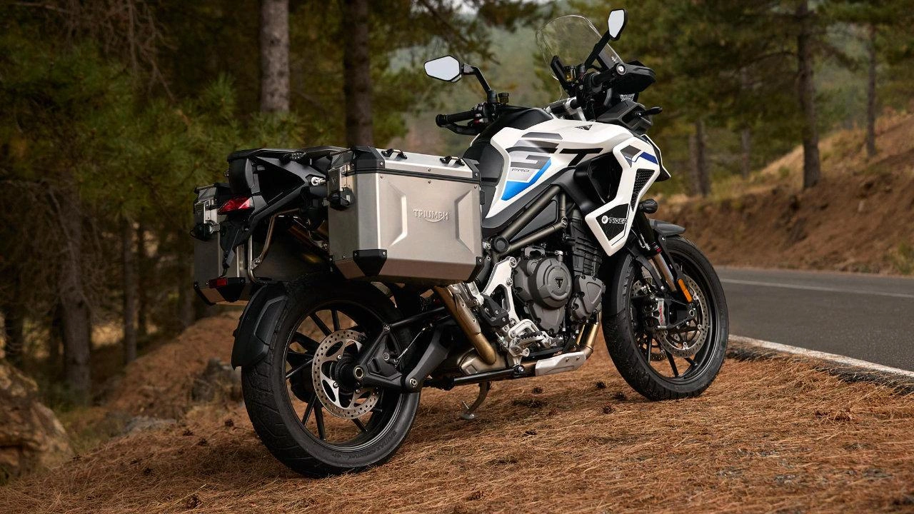 Triumph Tiger adventure motorcycle parked in a mountainous landscape