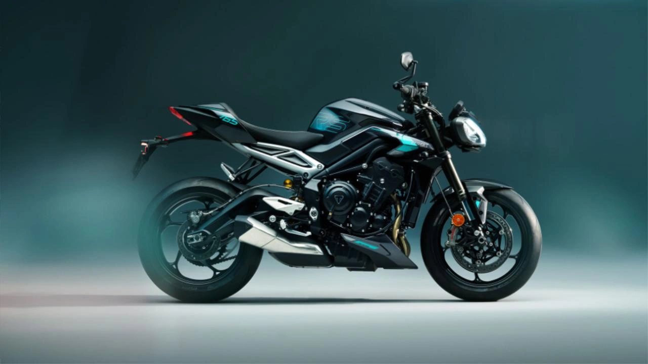 Triumph Street Triple sport roadster motorcycle leaning into a curve on a racetrack