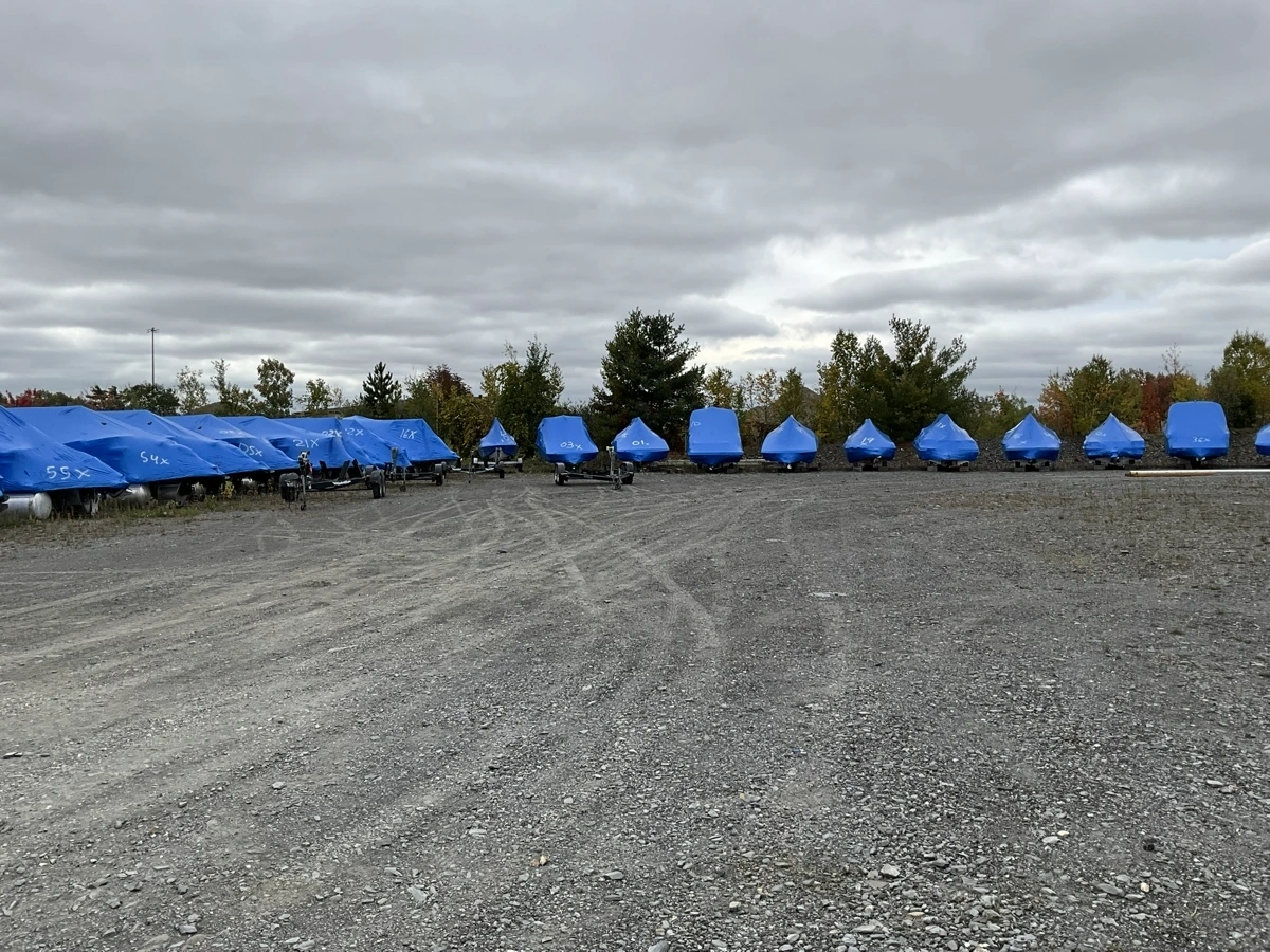 Overview of an outdoor storage yard with boats protected for winter in Sherbrooke.