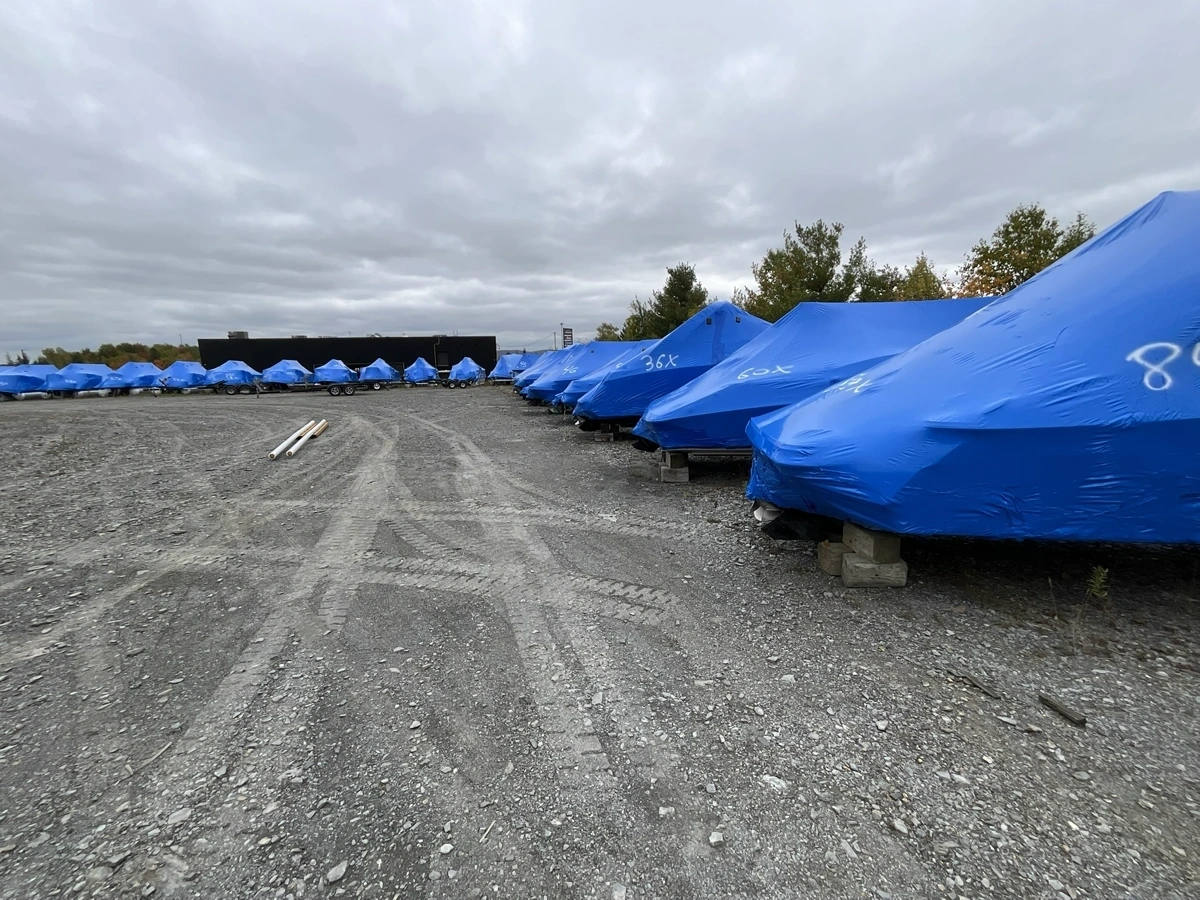 Boats protected by blue covers for winter storage at Estrie Marine in Sherbrooke.