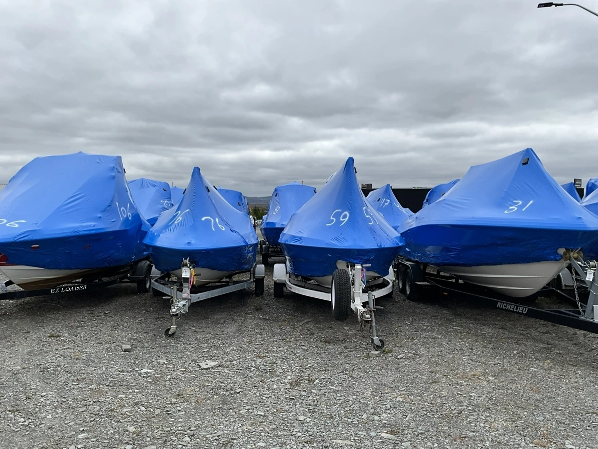 Front view of boats on trailers wrapped for winter storage at Estrie Marine.