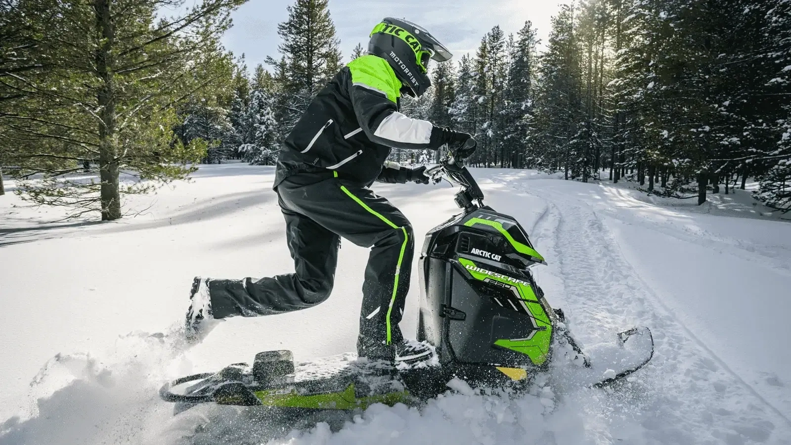 Rider standing on a single-ski 2027 Arctic Cat Widescape WS 250 in a snowy forest.