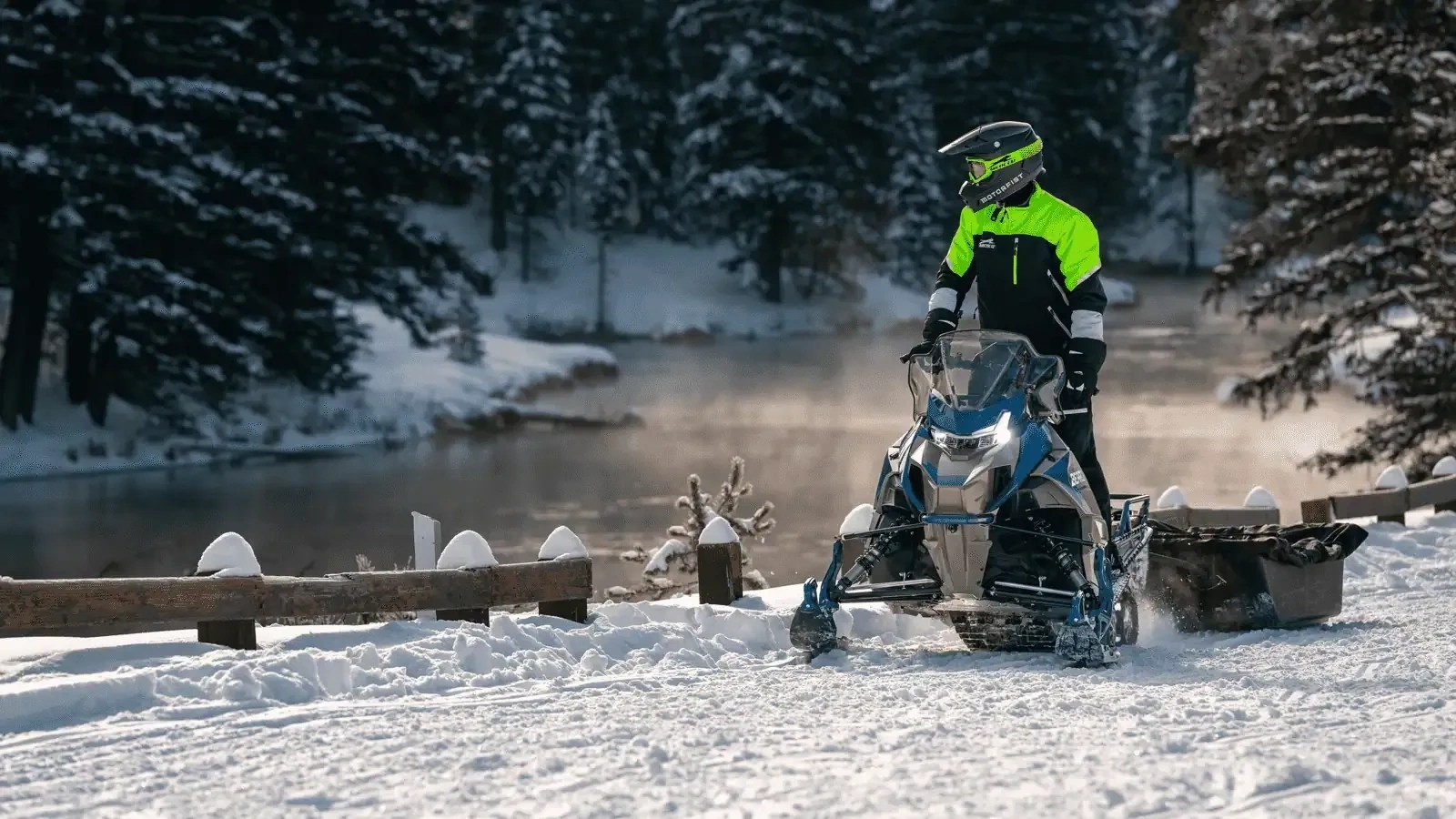 2027 Arctic Cat Bearcat 600 LT utility snowmobile with its rider in a snowy forest.