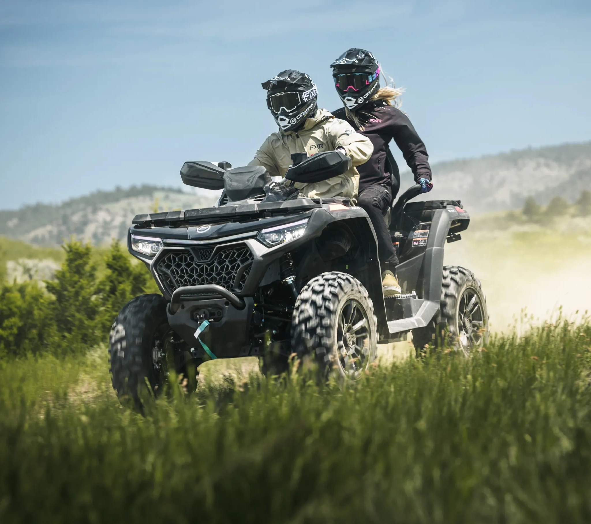 2027 CFMOTO CFORCE 800 TOURING ATV with a rider and passenger travelling through a field.