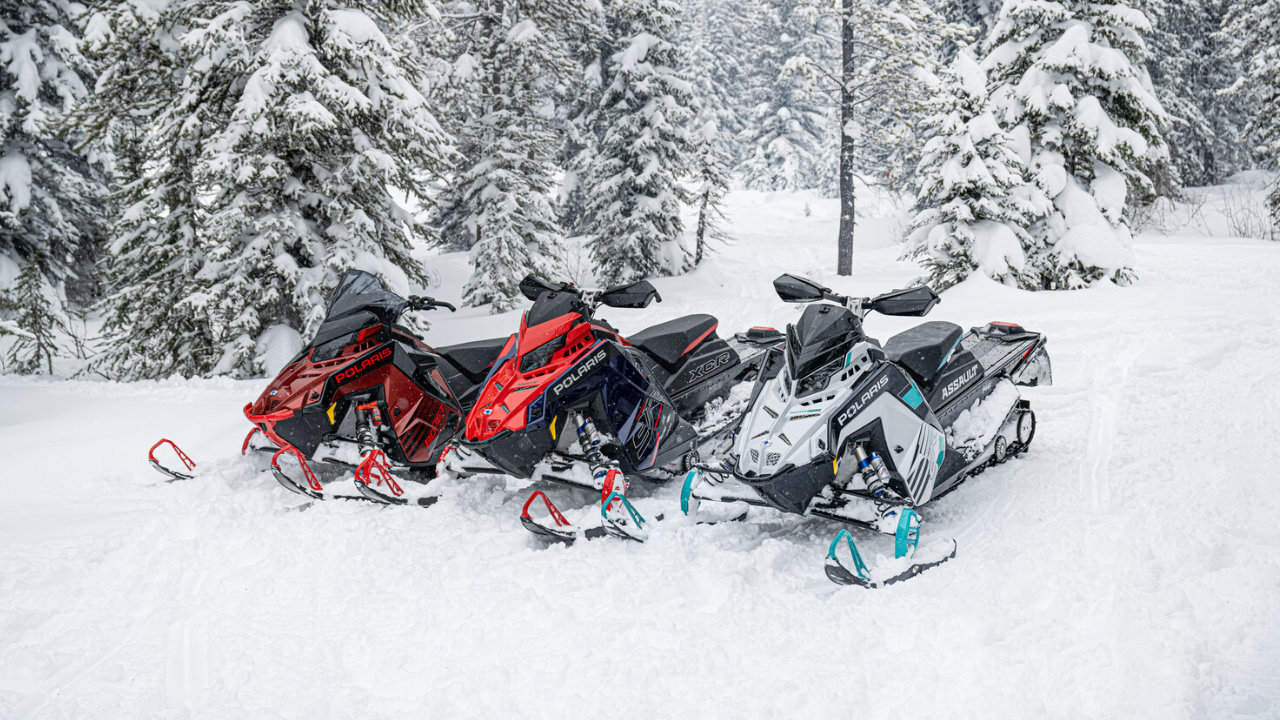Trio of Polaris snowmobile in the snow