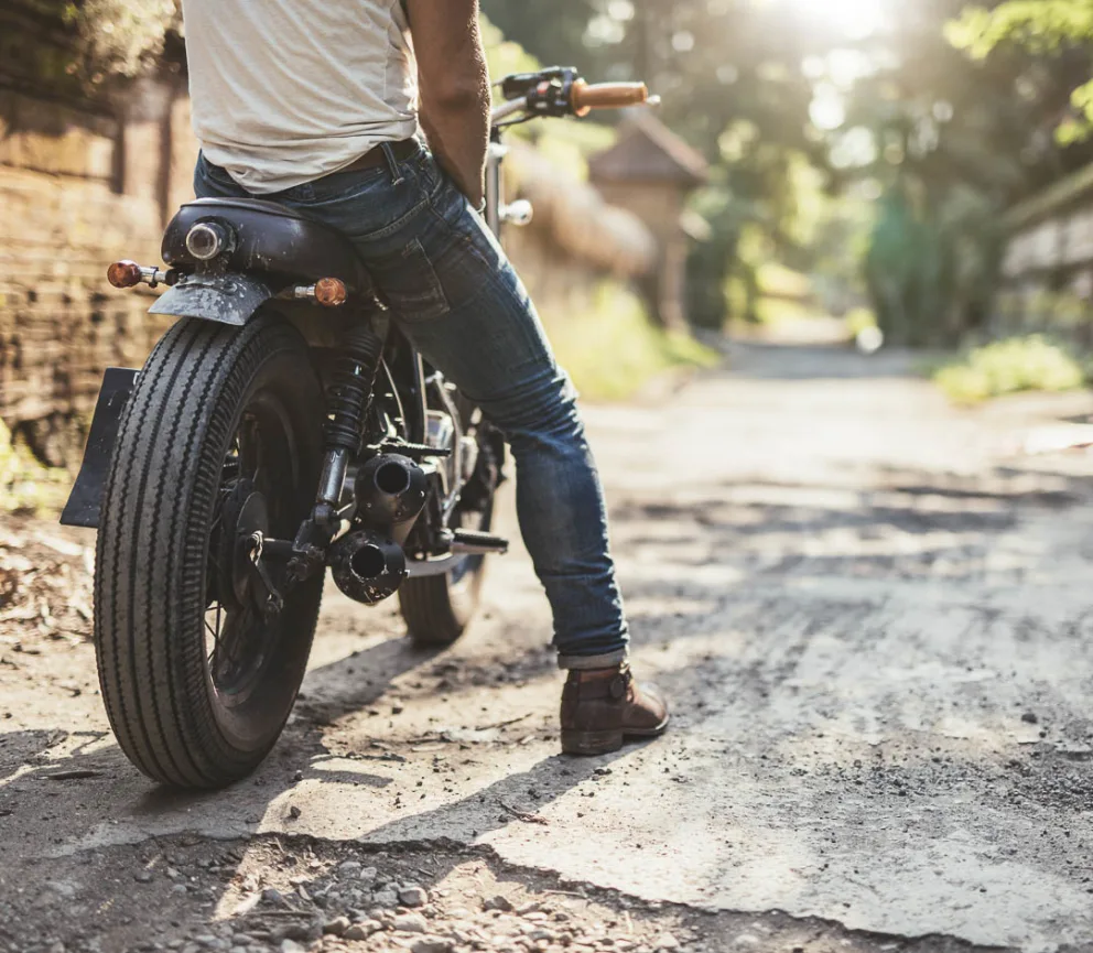 rear view of a motorcycle with a man sitting on top