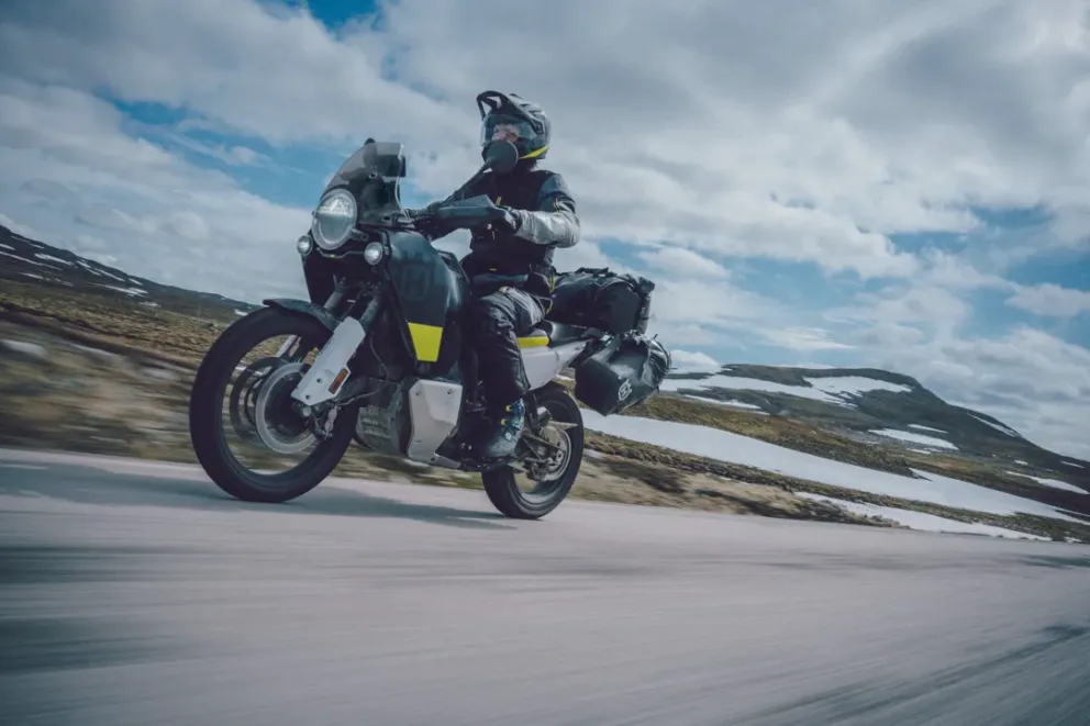 Person driving the Husqvarna brand Norden motorcycle.