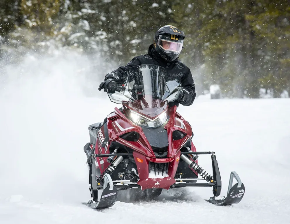 Ski and Runner of a Yamaha snowmobile driving on snow.
